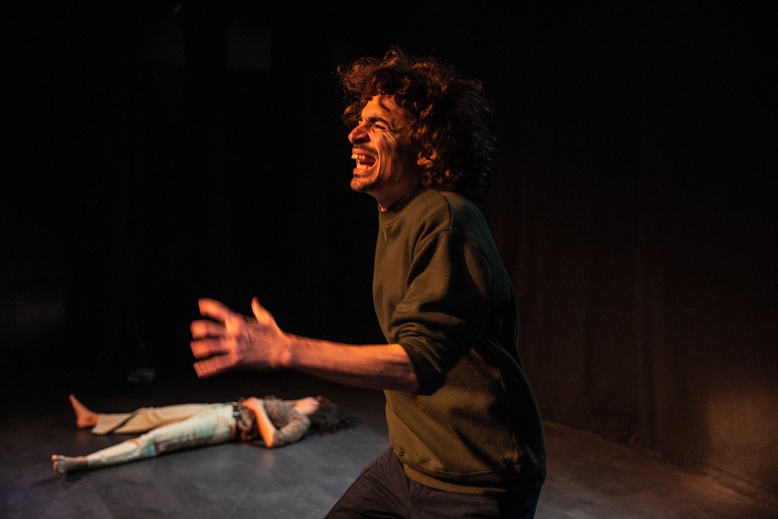 Comédien exprimant une forte émotion sur scène pendant une représentation du spectacle Mal à Dire.